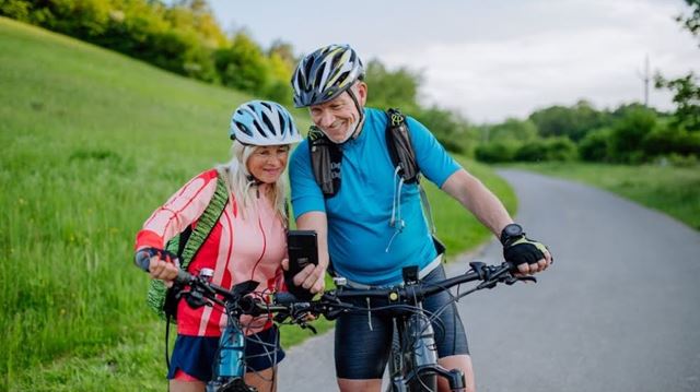 Senior couple on bikes taking a selfie